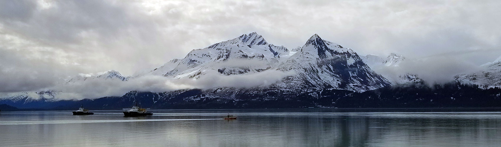 Snow covered mountains on the water in Valdez Alaska