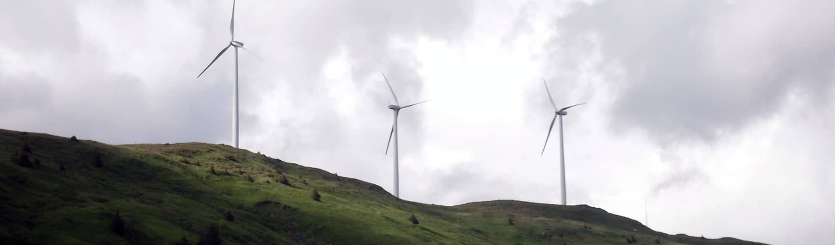 Three windmills on a hillside in Kodiak, Alaska